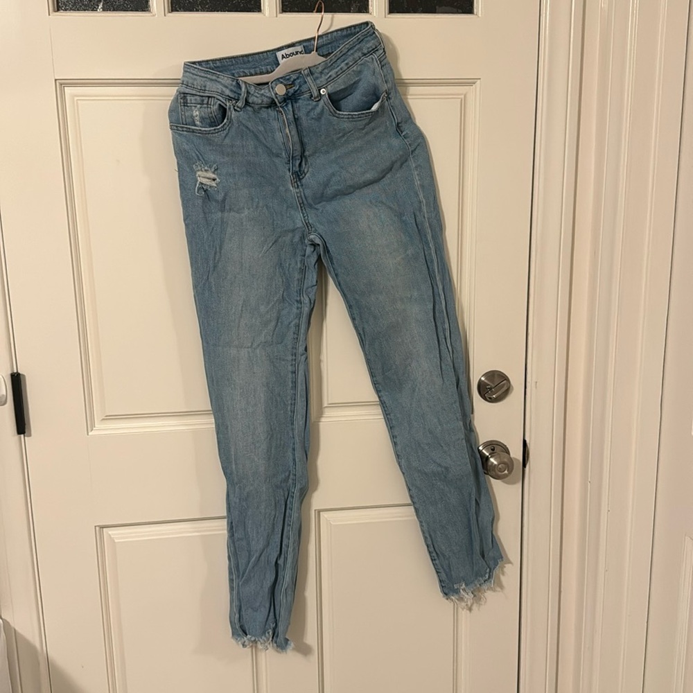 High rise light blue jeans. Distressed bottoms